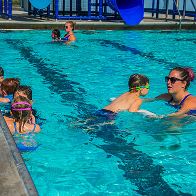 Lifeguards teaching kids how to swim